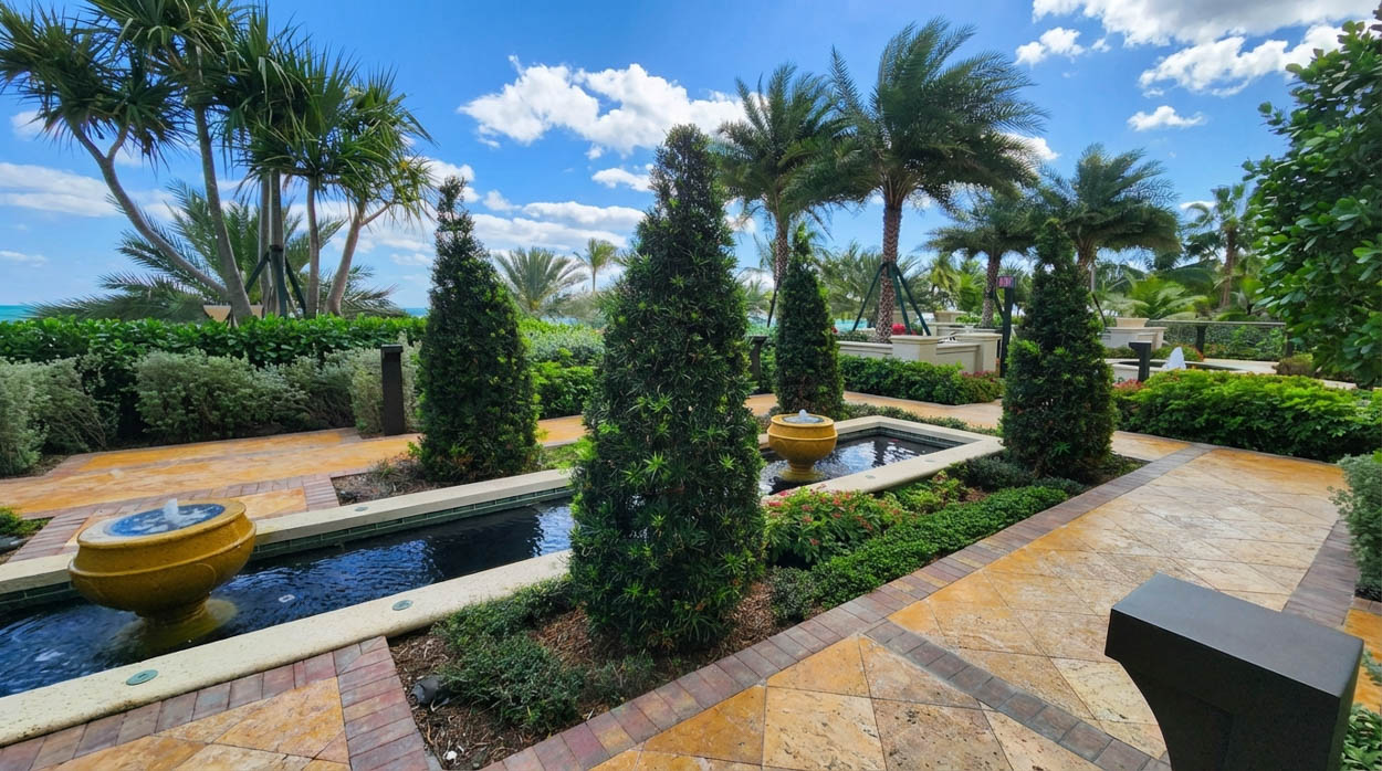 High-end garden landscaping with water features and stone paths built by Florida landscape contractors.