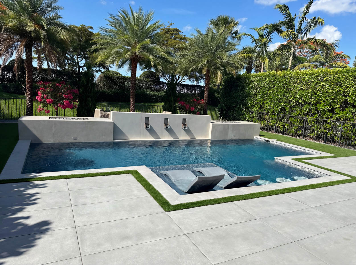 Modern pool renovation with clean lines, integrated spa and minimalist deck, completed by Florida pool remodeling experts.