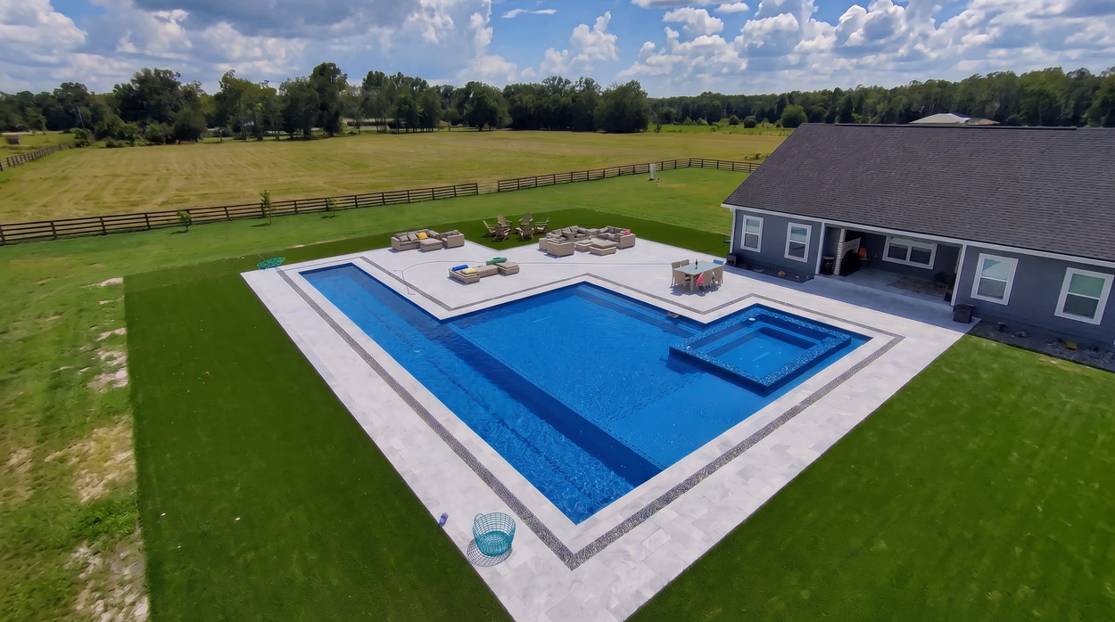 Custom pool and raised spa with a wide paver deck on North Florida acreage, built by Mr & Mrs Outdoor Living